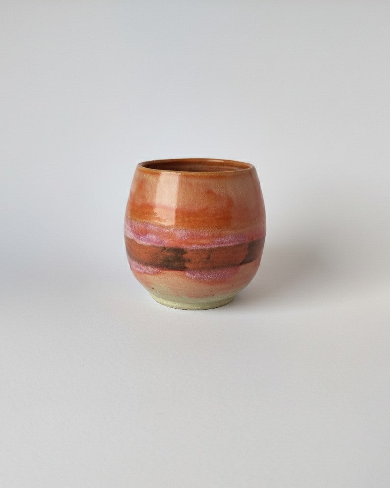 Ceramic cup with a marbled design on a white background